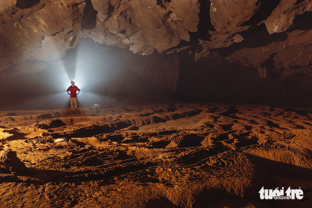 A caver poses for a photo near a giant stalactite in Va Cave in Quang Binh Province, central Vietnam. Photo: Ngo Tran Hai An