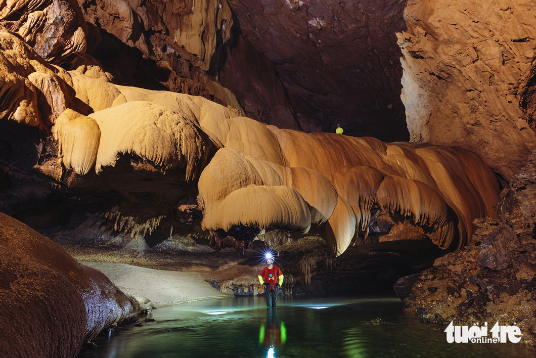 A caver stands in the middle of an underground river in Va Cave in Quang Binh Province, central Vietnam. Photo: Ngo Tran Hai An