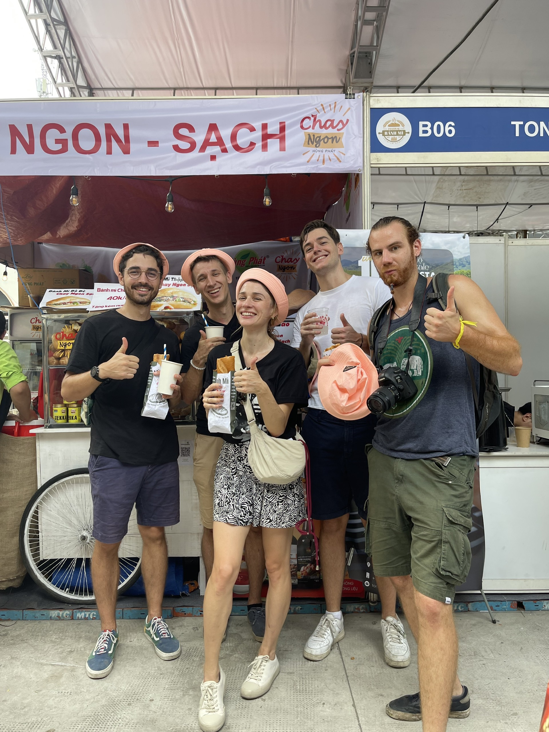 A group of festival-goers pose with their vegan banh mi bought at the booth. Photo: Supplied