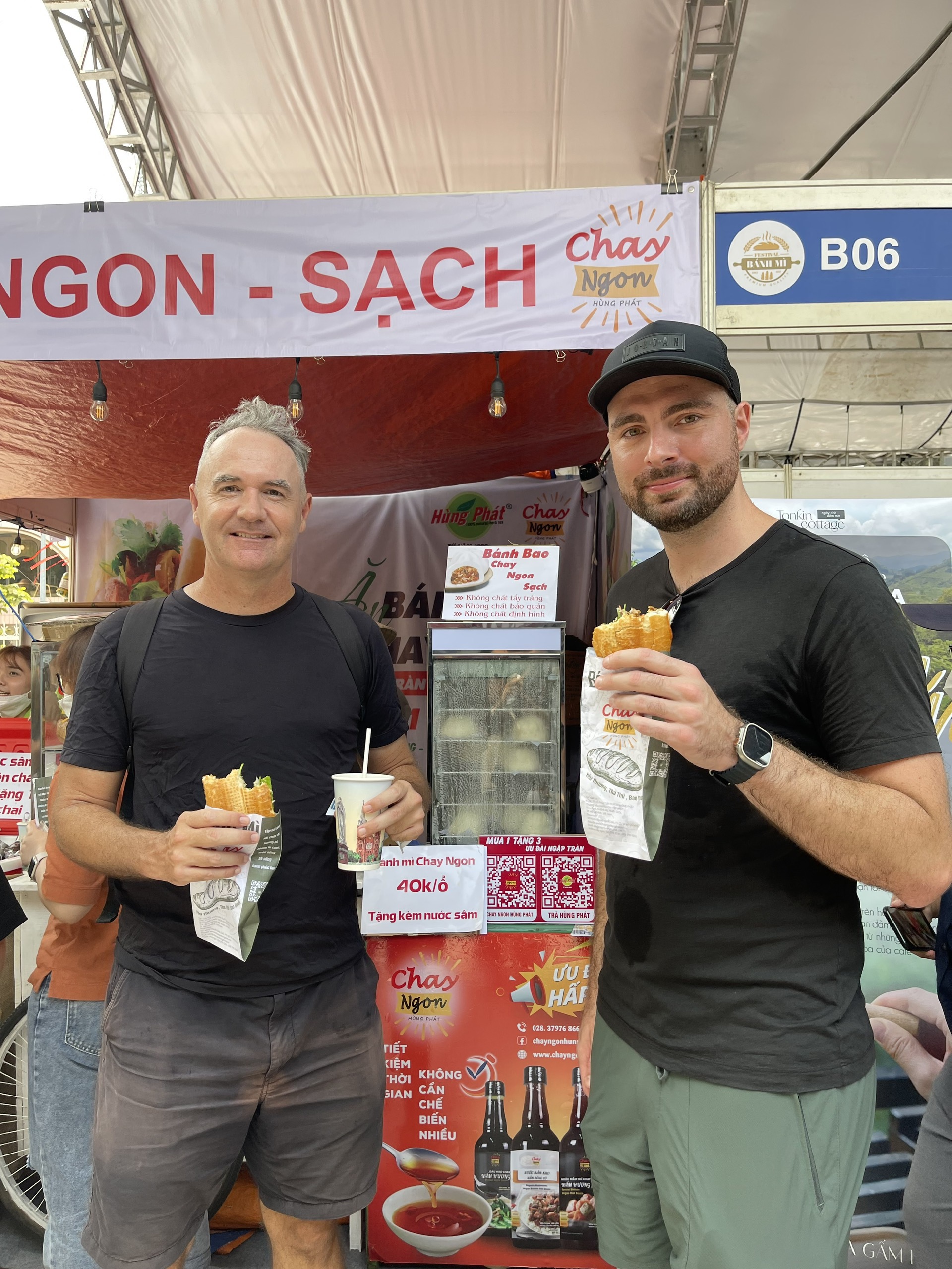 Two visitors enjoy their vegan banh mi bought at the booth. Photo: Supplied