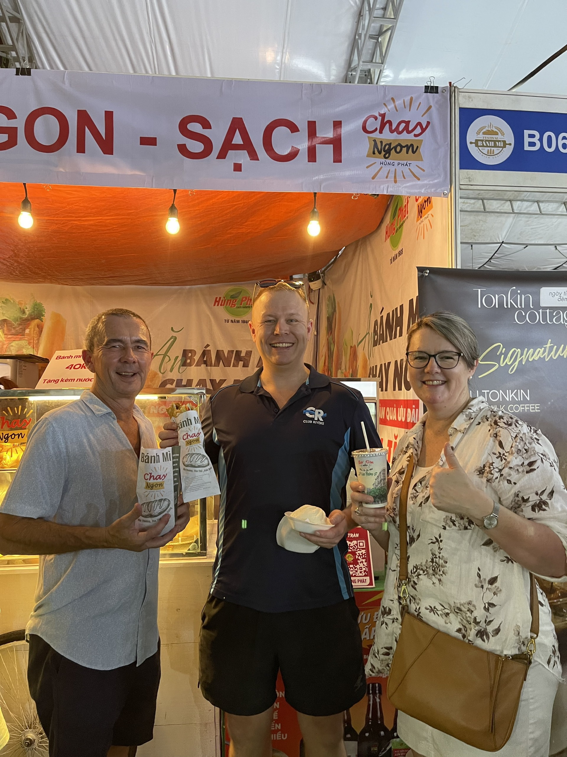 Festival-goers pose with their vegan banh mi bought at the booth. Photo: Supplied