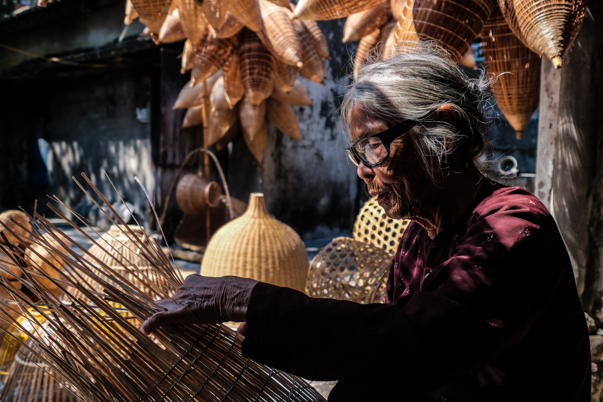An elderly woman is seen making bamboo fishing traps at Thu Sy craft village in Thu Sy Commune, Hung Yen Province, Vietnam. Photo: Nam Tran / Tuoi Tre News