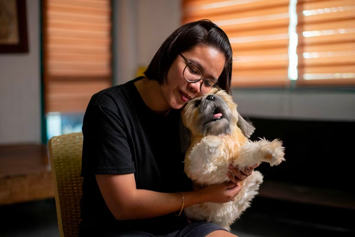 Herminhilda del Rosario poses for a picture with a realistic pet plushie of her departed dog Luna, at her home in Hagonoy town, Bulacan province, Philippines, March 16, 2023. Photo: Reuters