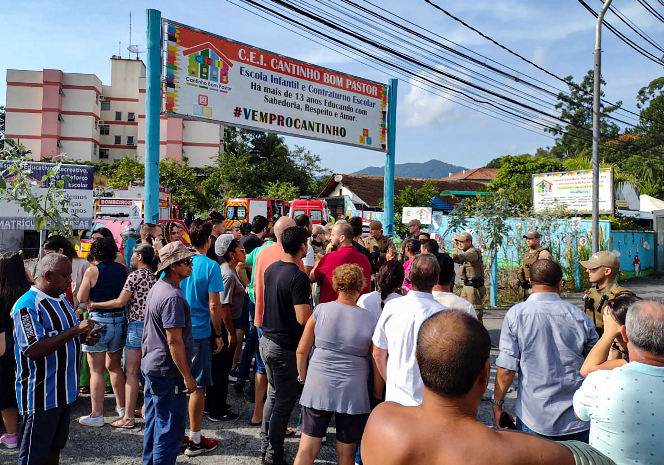People stand outside a pre-school after a 25-year-old man attacked children, killing several and injuring others, according to local police and hospital, in Blumenau, in the southern Brazilian state of Santa Catarina, Brazil April 5, 2023. Photo: Reuters
