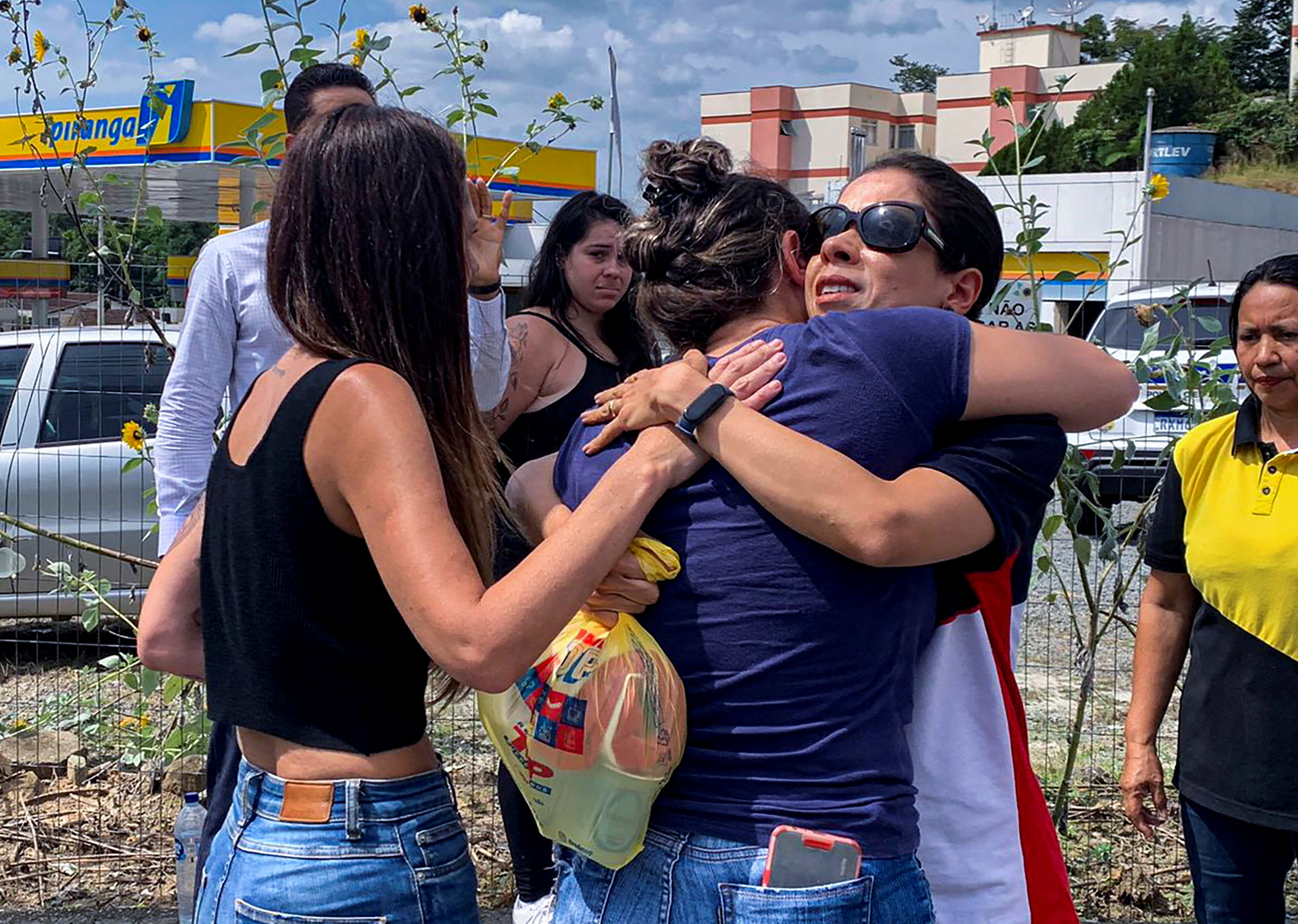 Women hug outside a pre-school after a 25-year-old man attacked children, killing several and injuring others, according to local police and hospital, in Blumenau, in the southern Brazilian state of Santa Catarina, Brazil April 5, 2023. Photo: Reuters