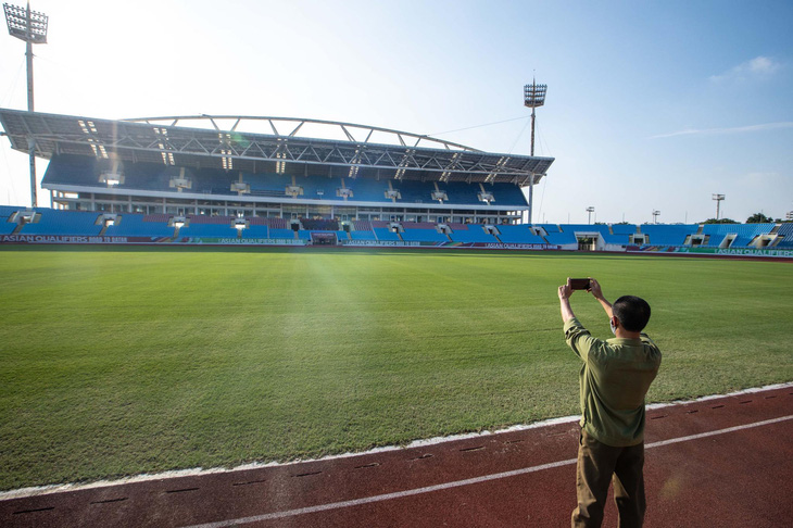 A man takes photos at My Dinh National Stadium in Hanoi, Vietnam. Photo: Nguyen Khanh / Tuoi Tre