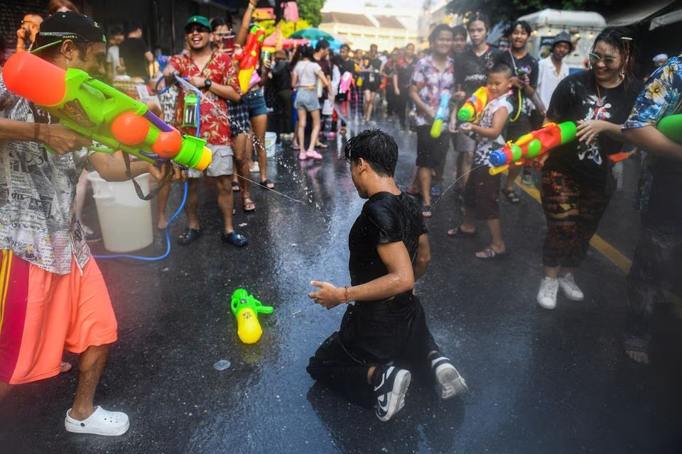 People play with water as they celebrate during the Songkran holiday which marks the Thai New Year in Bangkok, Thailand, April 13. Photo: Reuters