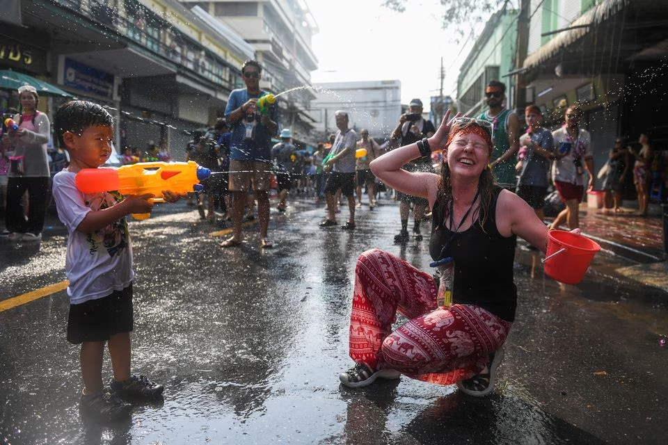 A boy and a tourist play with water as they celebrate during the Songkran holiday which marks the Thai New Year in Bangkok, Thailand, April 13. Photo: Reuters