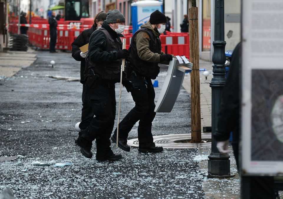 Law enforcement officers investigate the scene following an attack on bank ATMs in Ratingen, Germany, March 15, 2023. Courtesy of Achim Blazy/Handout via Reuters