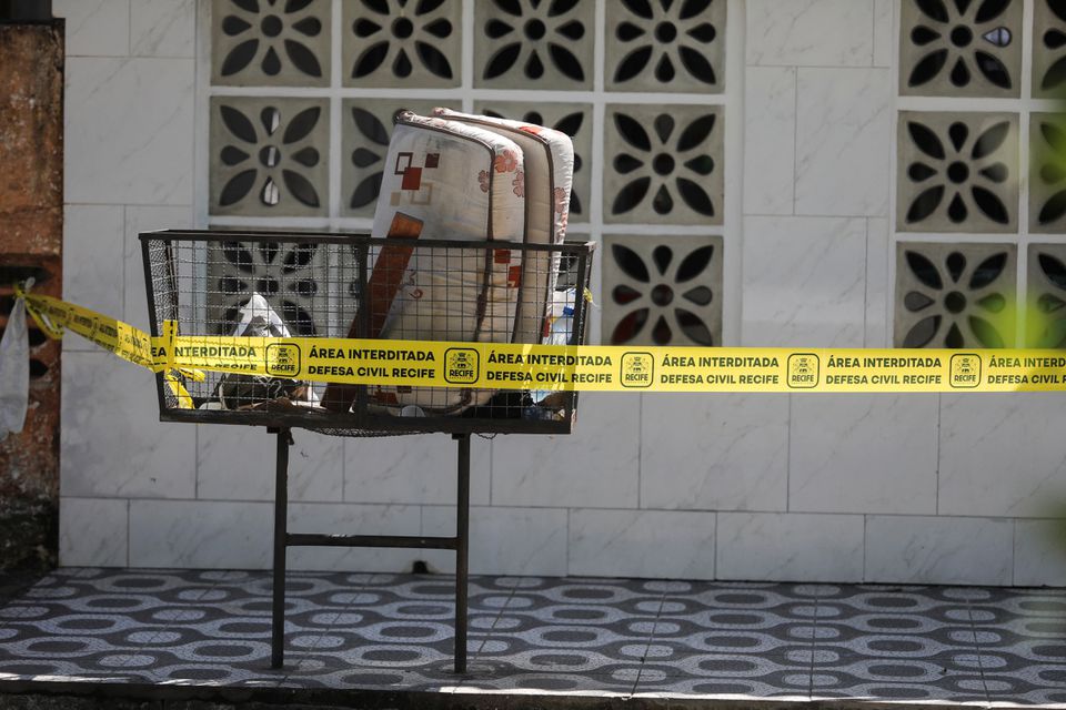 A mattress is seen behind a civil defence tape outside Lar Paulo de Tarso shelter for children, after a deadly fire in Recife, Pernambuco state, Brazil April 14, 2023. Photo: Reuters