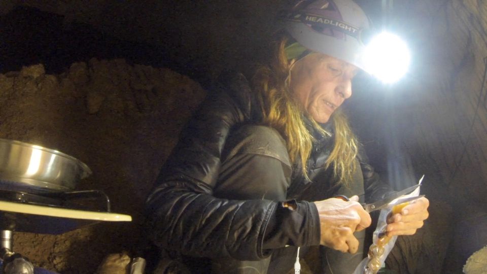 Beatriz Flamini, a Spanish mountaineer who has been isolated for 500 days in a cave is pictured during her daily life at the cave in Motril, Spain in this screen grab taken from a handout video in November 2021. Dokumalia Producciones/Handout via Reuters