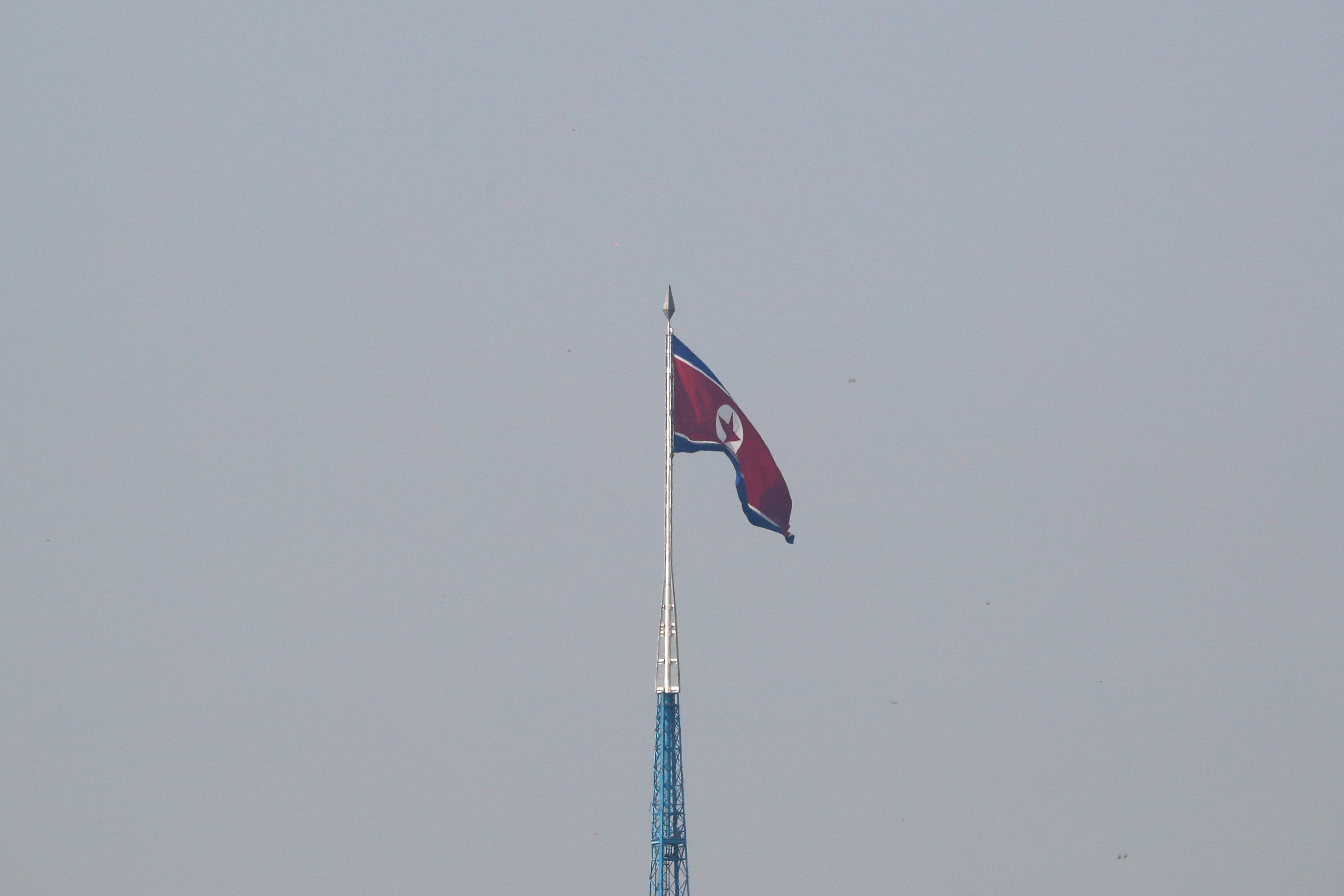 A North Korean flag flutters on top of the 160-metre tall tower at North Korea's propaganda village of Gijungdong, in this picture taken from Tae Sung freedom village near the Military Demarcation Line (MDL), inside the demilitarised zone separating the two Koreas, in Paju, South Korea, September 30, 2019. Photo: Reuters