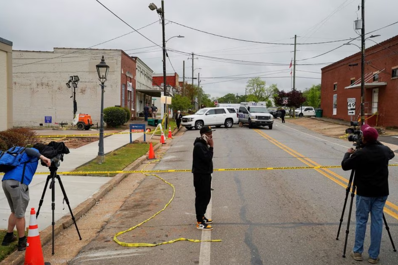 Community members and media stand near the crime scene, a day after a shooting at a teenager's birthday party in a dance studio, in Dadeville, Alabama, U.S., April 16, 2023. Photo: Reuters