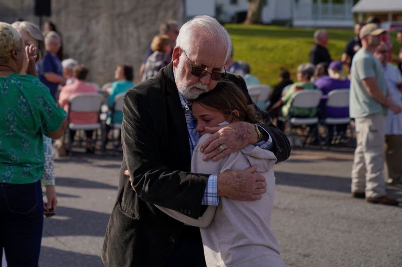 Community members embrace each other during a vigil the day after a shooting during a teenager's birthday party at Mahogany Masterpiece Dance Studio in Dadeville, Alabama, U.S., April 16, 2023. Photo: Reuters