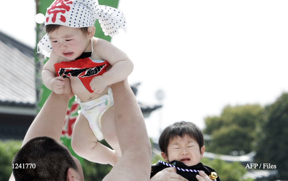 Crying babies are carried by student sumo wrestlers during the 'Baby-cry Sumo' competition at Tokyo's Sensoji temple on April 27, 2008. Photo: AFP