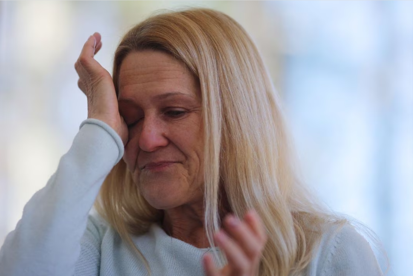 Wendy Nelson, whose mother died from Alzheimer's disease and father suffers from it, becomes emotional when talking about the potential of also getting the disease and how that would affect how she would want the end of her life to play out, during an interview with Reuters at her home in Foxborough, Massachusetts, U.S., March 21, 2023. A genetic test through 23andMe shows that Wendy carries two APOE4 gene variants, and her three daughters each carry one APOE4 gene variant, indicating an increased risk of Alzheimer's disease. Photo: Reuters