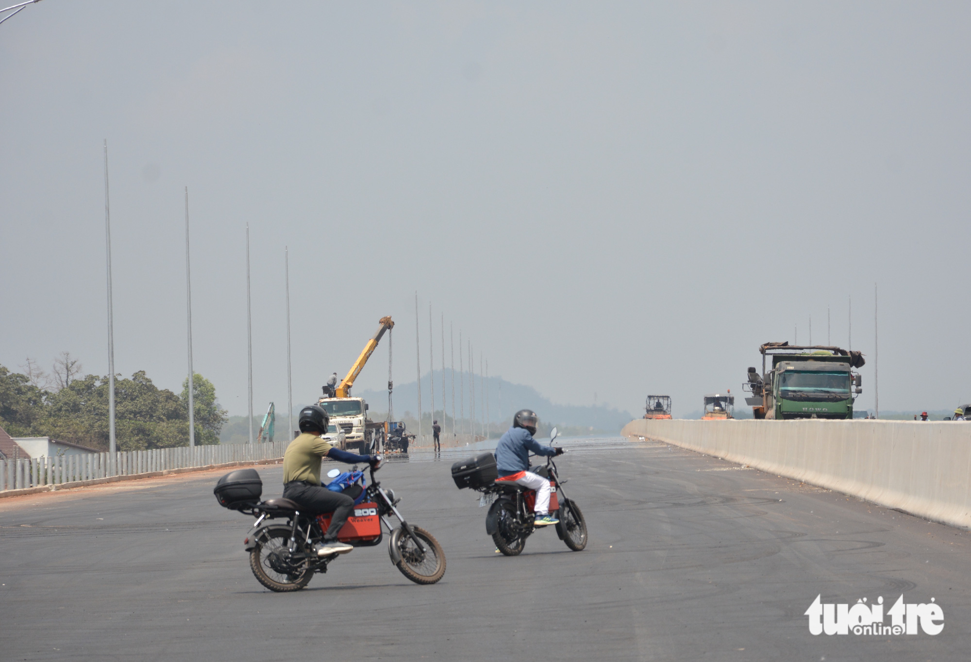 Two motorcyclists trespass the under-construction Phan Thiet-Dau Giay Expressway in southern Vietnam, April 2023. Photo: Duc Trong / Tuoi Tre