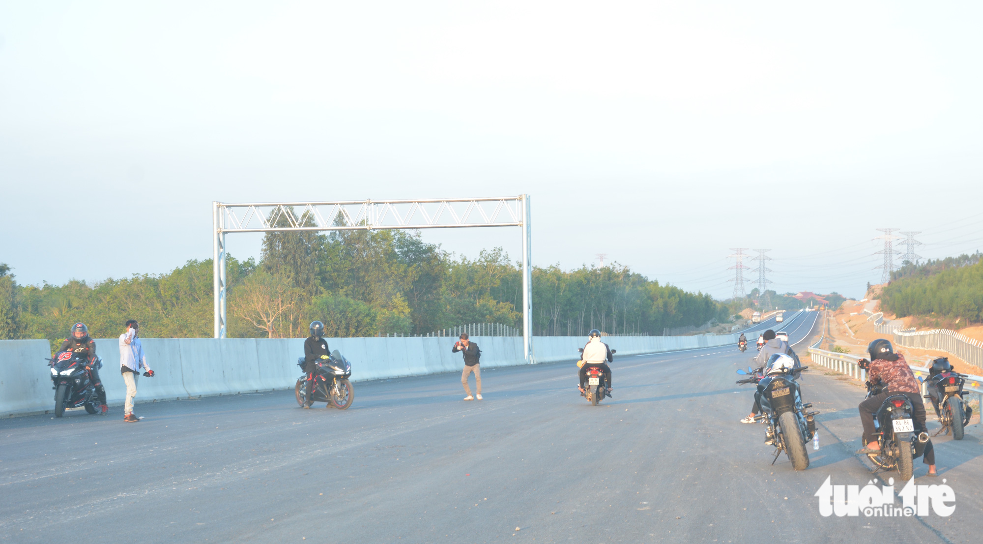 A group of motorcyclists take photos on the under-construction Phan Thiet-Dau Giay Expressway in southern Vietnam, April 2023. Photo: Duc Trong / Tuoi Tre