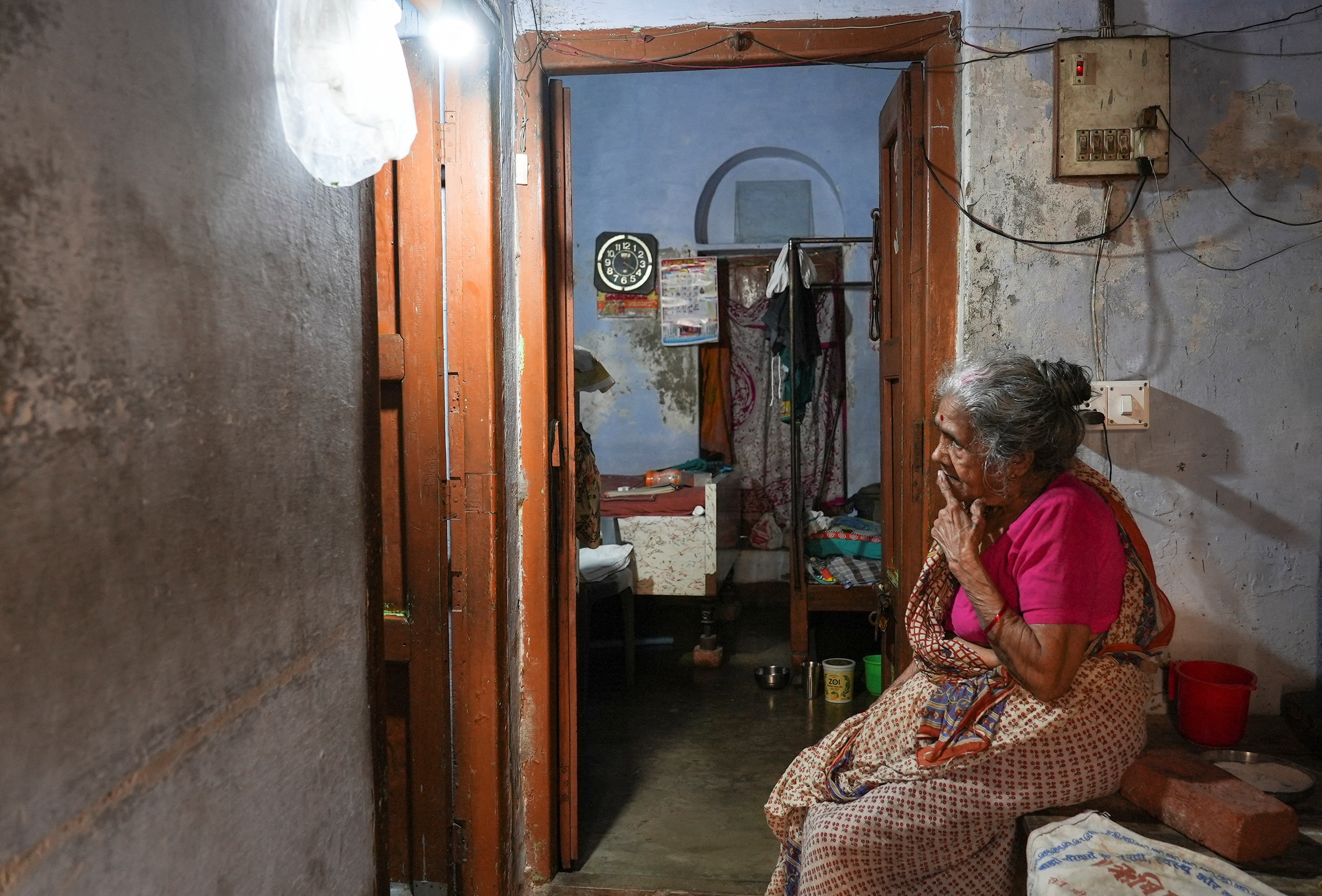 Ram Pyari, a resident of Mumukshu Bhavan, a community home for elderly wishing to live and end their twilight years in the sacred city of Varanasi, sits in her doorway way in Varanasi, India, March 7, 2023. Photo: Reuters