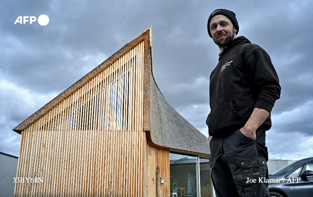 Jacobus van Hoorne, a 37-year-old former physicist at Cern and now reed farmer, poses in front of his house for which he built the reed roof at Weiden am See, Austria on March 9, 2023. Photo: AFP
