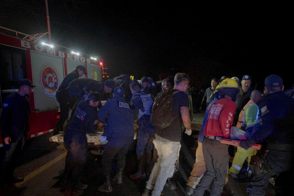 Emergency personnel work on the site where a bus carrying tourists traveling to Guayabitos overturned, in Compostela, Nayarit state, Mexico in this handout image obtained from social media April 30, 2023. Secretaria de Seguridad y Proteccion Ciudadana de Nayarit/Handout via Reuters