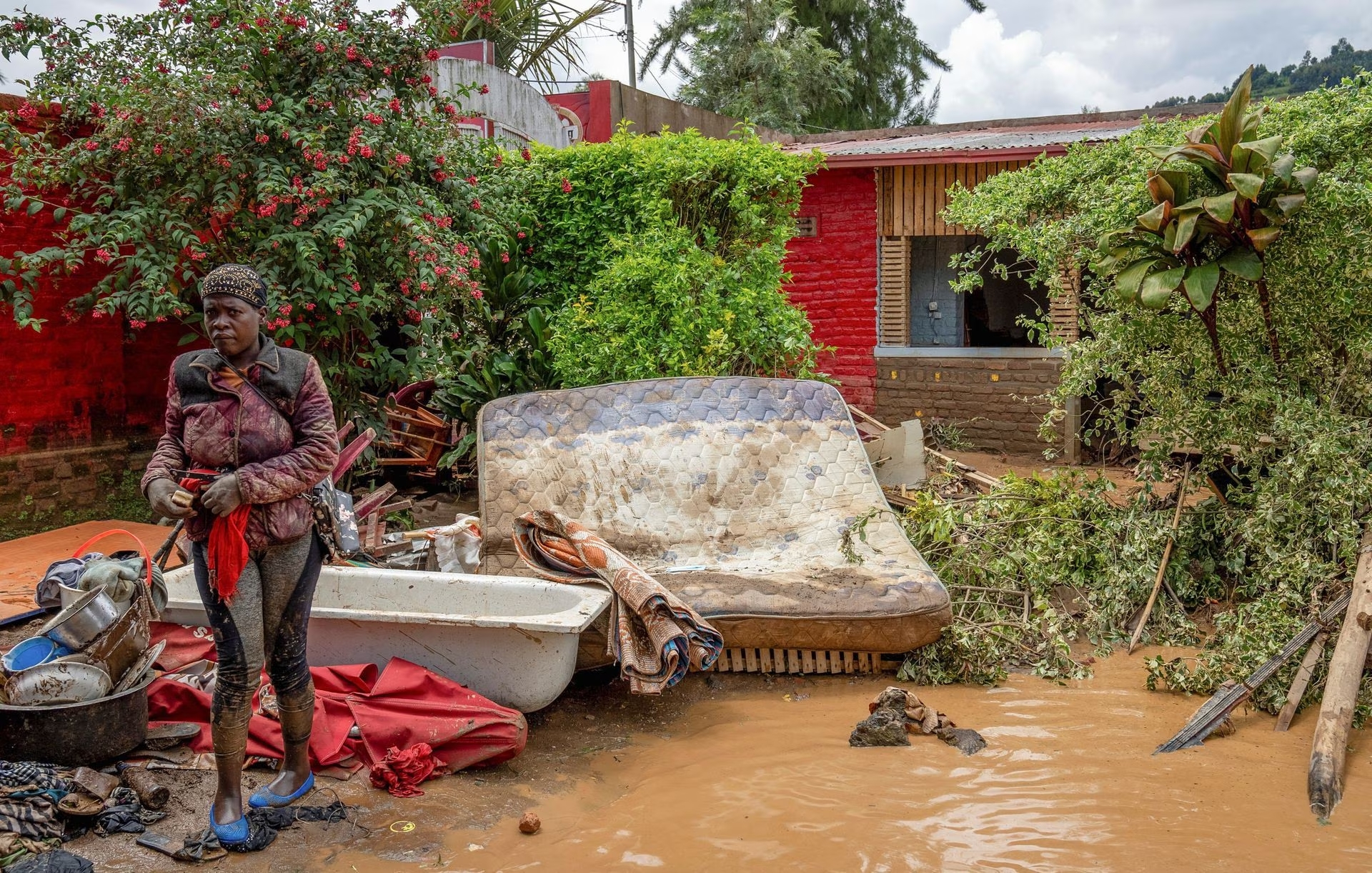 A resident salvages her household items washed away following rains that triggered flooding and landslides in Rubavu district, Western province, Rwanda May 3, 2023. Photo: Reuters