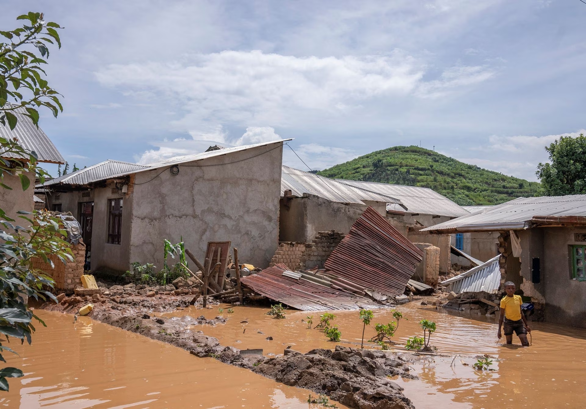 A boy wades through waters after their home was swamped, following rains that triggered flooding and landslides in Rubavu district, Western province, Rwanda May 3, 2023. Photo: Reuters