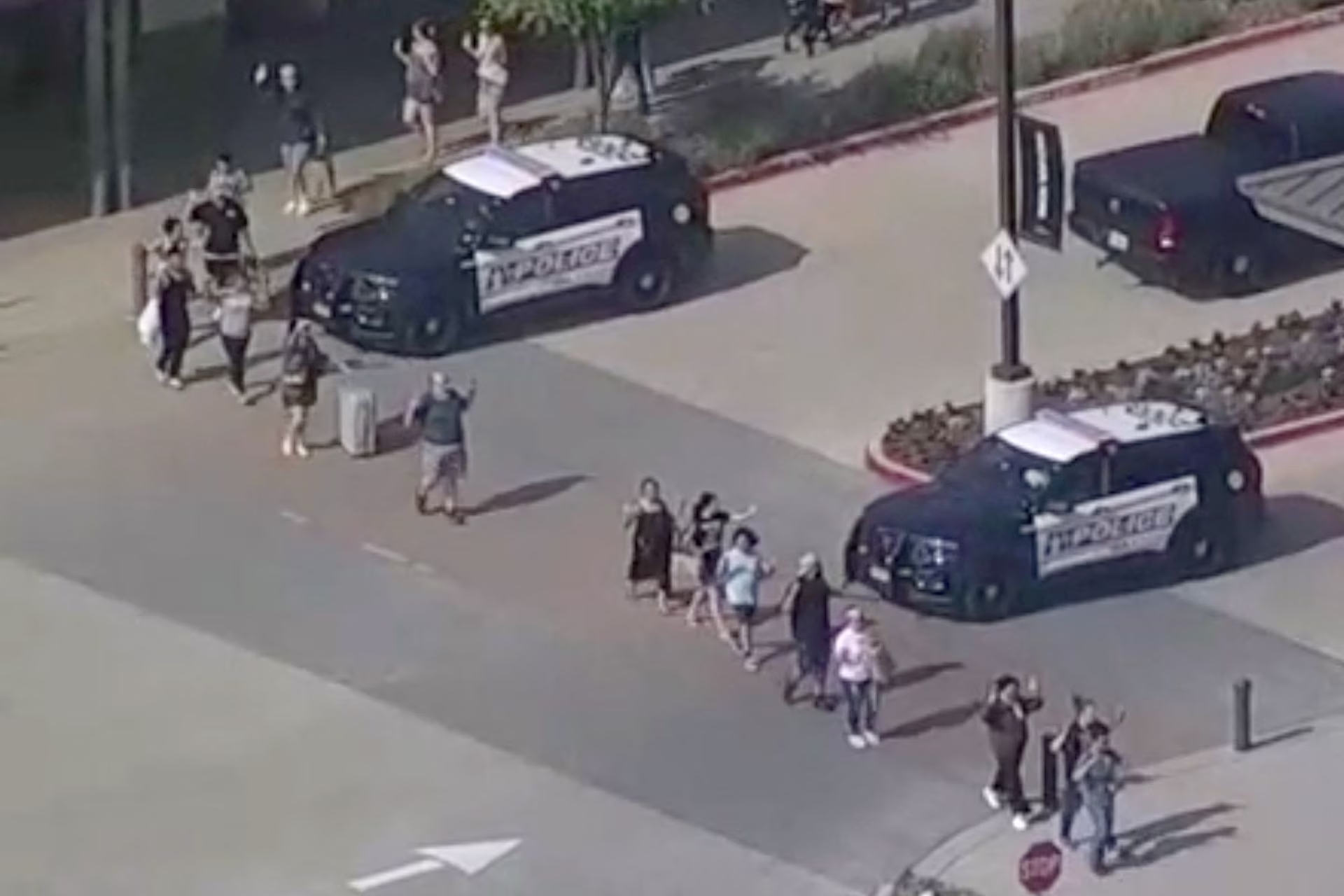 Shoppers leave with hands up as police respond to a shooting in the Dallas area's Allen Premium Outlets, which authorities said has left multiple people injured in Allen, Texas, U.S. May 6, 2023 in a still image from video. Photo: Reuters