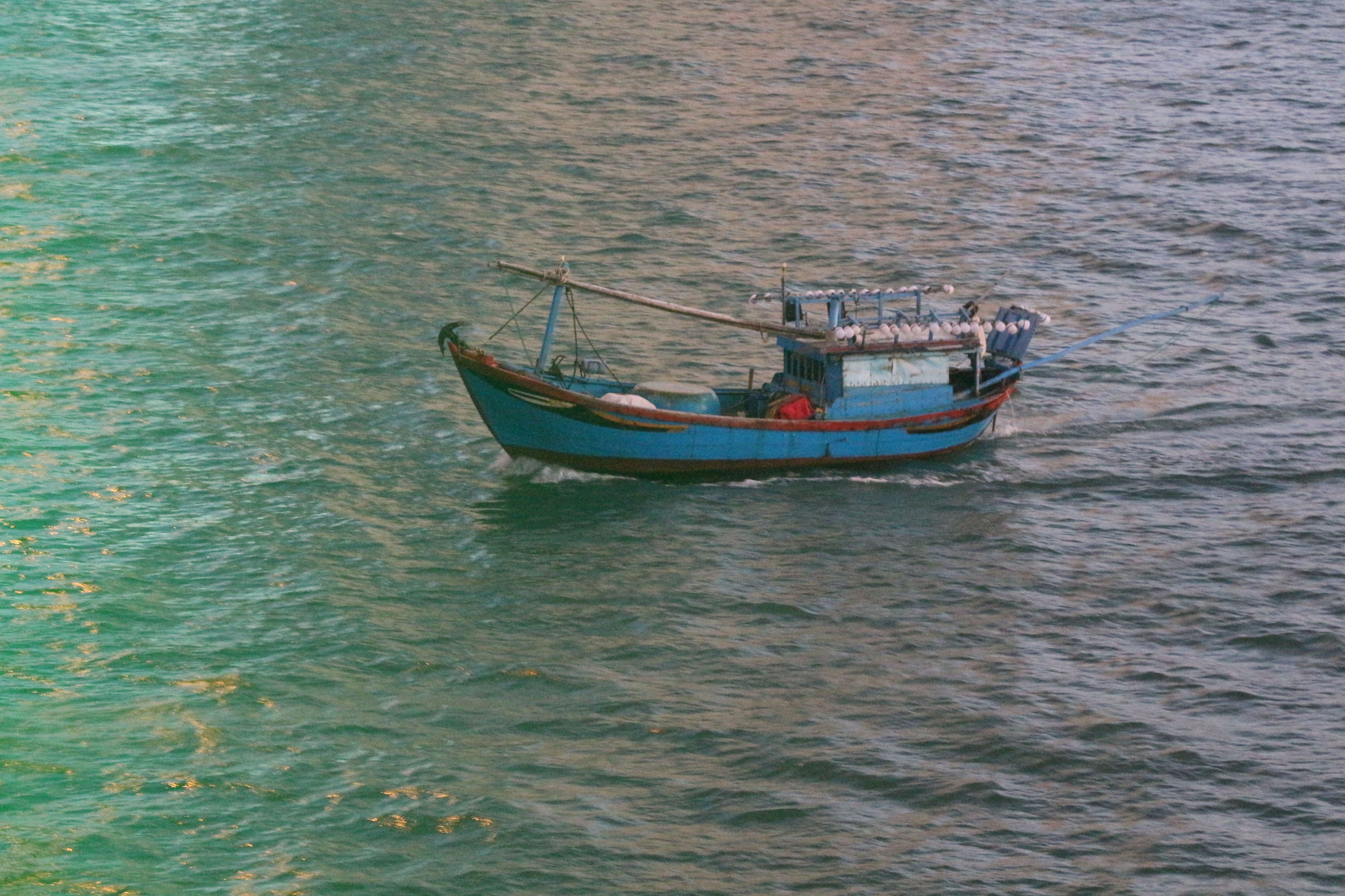 A fishing boat is on the water in Nha Trang City. Photo: Ray Kuschert / Tuoi Tre News