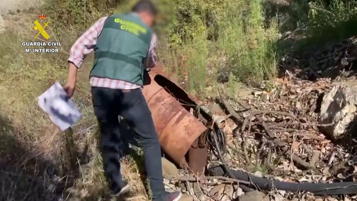A Spanish police officer uncovers an illegal well in Malaga province, Spain in this screen grab from an undated handout video. Photo: Reuters