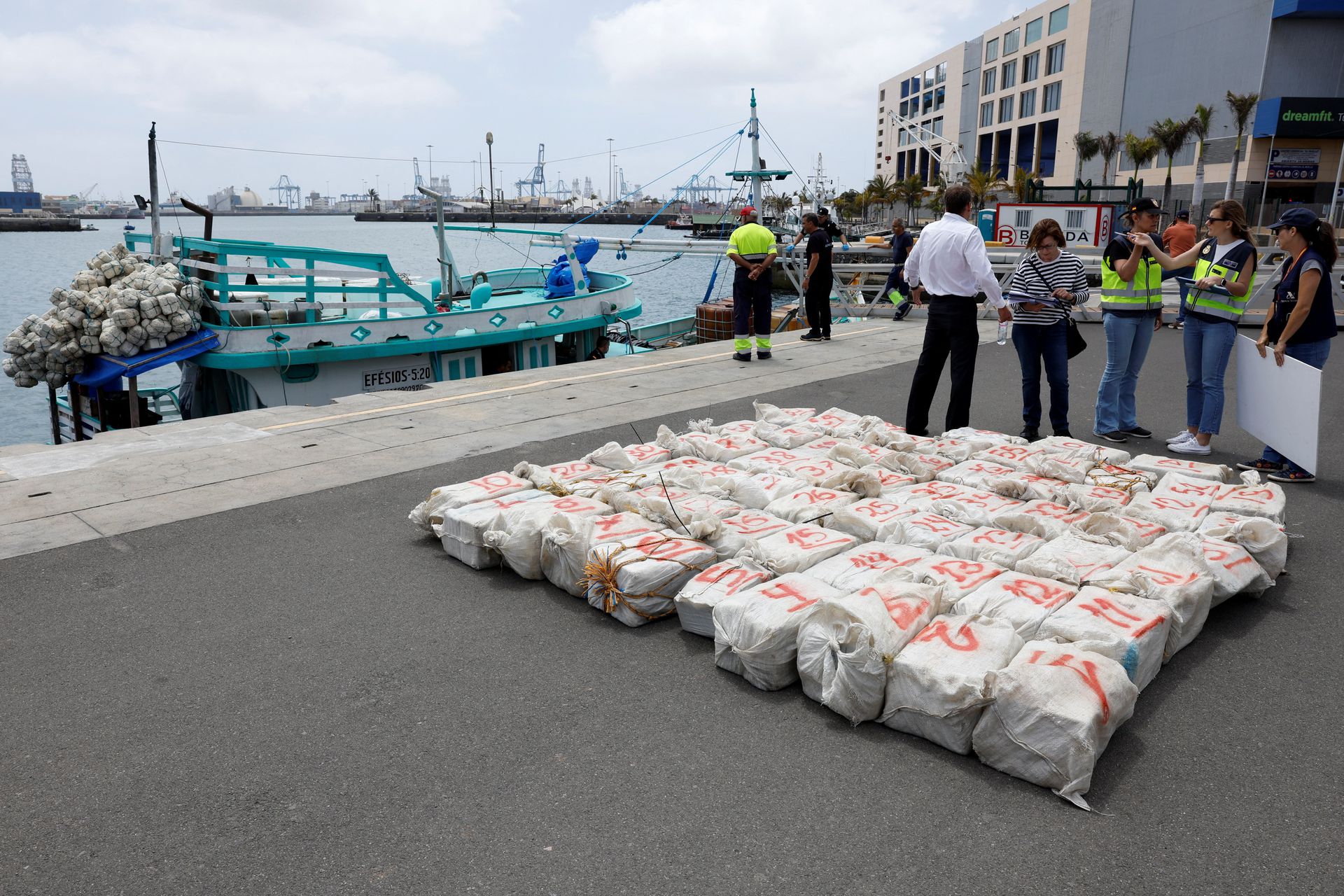 Drugs lie near a Brazilian fishing boat on which they were found, in the port of Las Palmas de Gran Canaria, after its crew members were detained by the Spanish police officers for transporting approximately 1500 kilograms of cocaine on board, Gran Canaria, Spain, May 12, 2023. Photo: Reuters