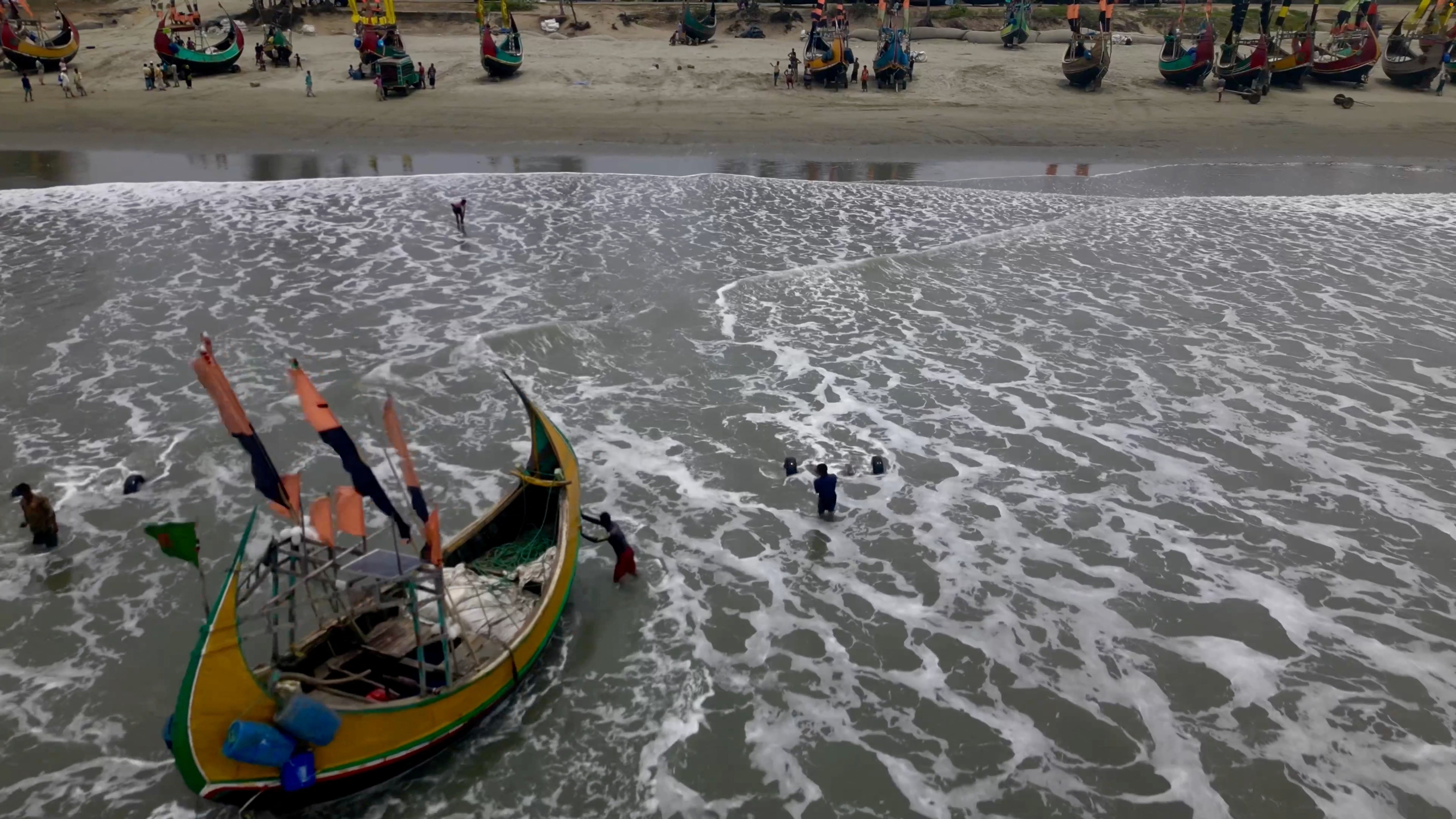 A drone view shows fishermen portaging their boats to safer ground due to Cyclone Mocha, in Teknaf Marine Drive, Cox's Bazar, Bangladesh May 12, 2023, in this screengrab obtained from a handout video. Photo: Reuters