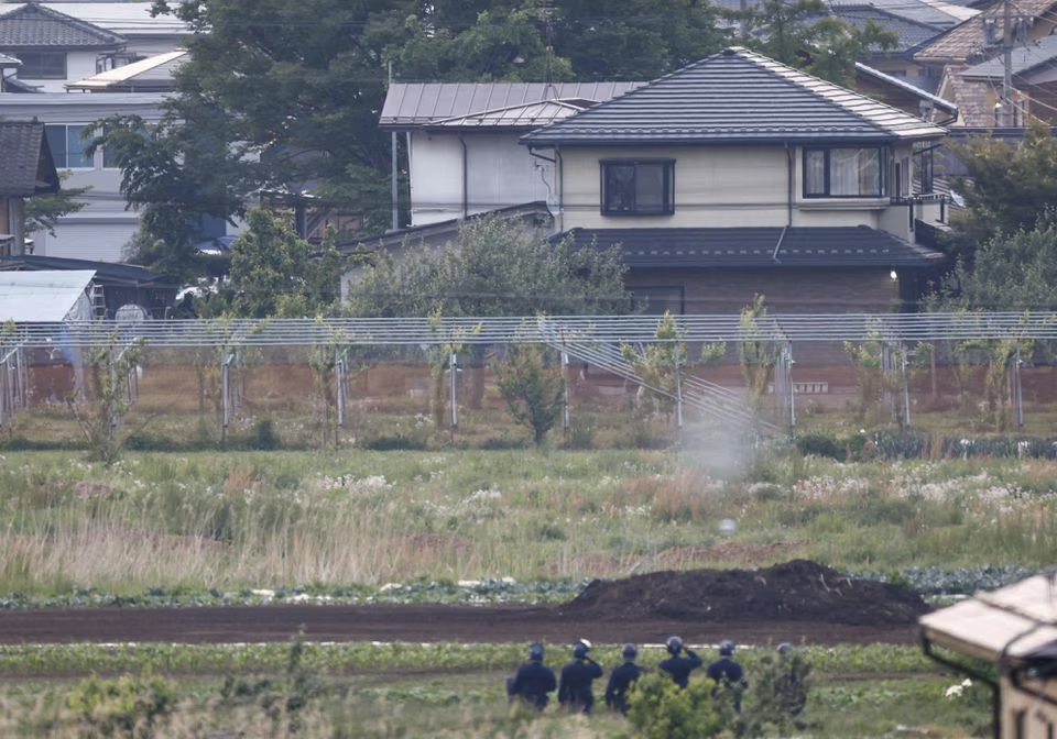 Police officers surround the scene of a stabbing and shooting incident in Nakano, Nagano Prefecture, central Japan, in this photo taken by Kyodo on May 26, 2023. Picture taken with a telephoto lens through obstacles. Mandatory credit Kyodo/via Reuters