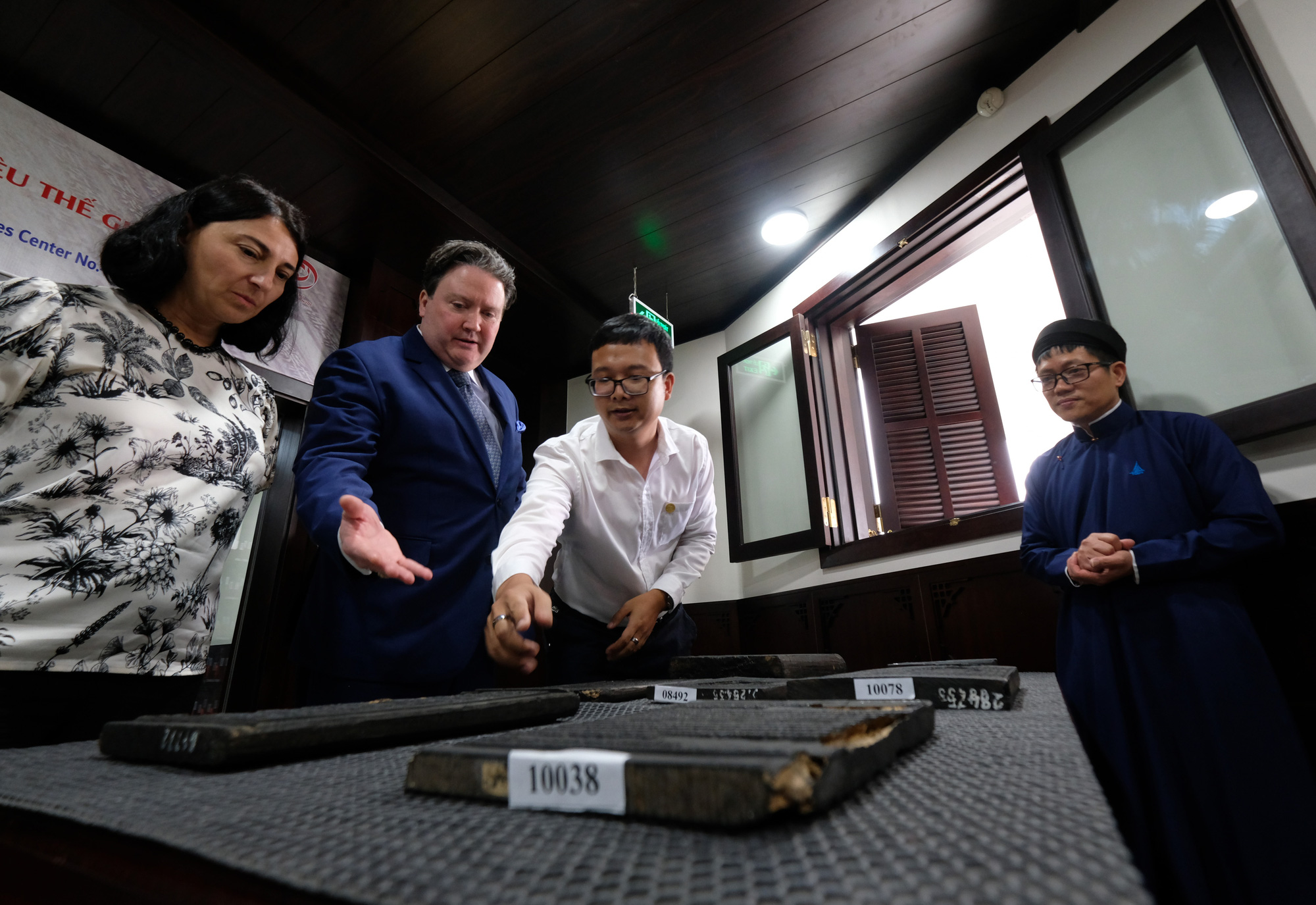 U.S. Ambassador to Vietnam Marc Knapper (L, 2nd) looks on as Nguyen Dynasty woodblock plates are conserved at the National Archives Center IV in Lam Dong Province, Vietnam, on May 25, 2023. Photo: M.V. / Tuoi Tre