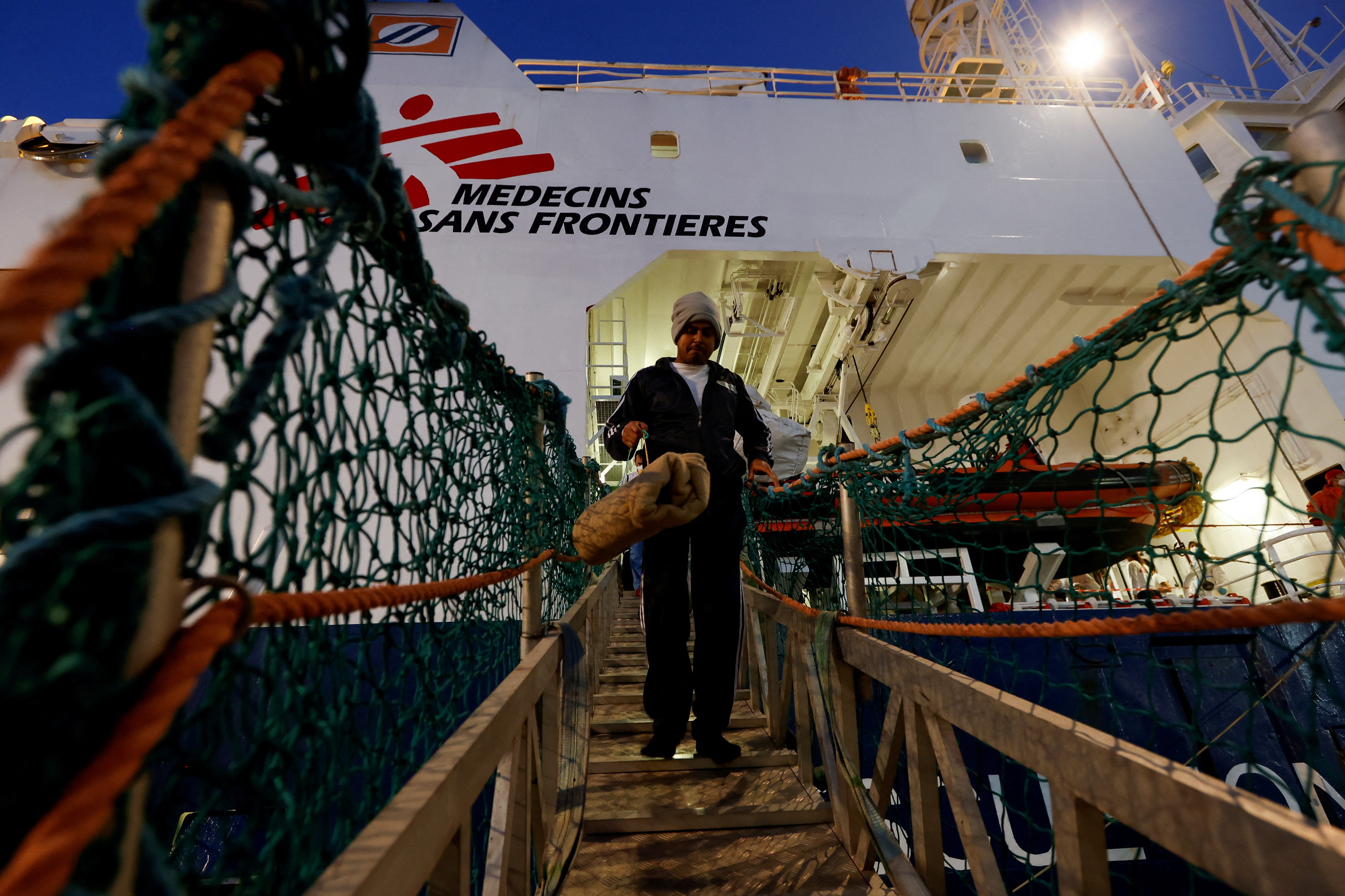 A migrant disembarks the Geo Barents rescue ship, operated by Medecins Sans Frontieres (Doctors Without Borders), in Bari, Italy March 26, 2023. Photo: Reuters