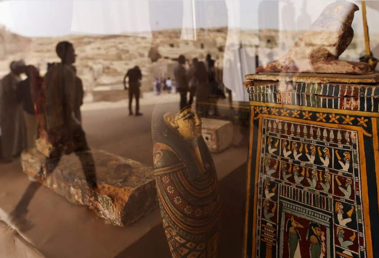 Reflections of people are seen on the unearthed ancient artefacts displayed after a conference to announce the newly discovered site where two embalming workshops for humans and animals along with two tombs and a collection of artefacts were found, near Egypt's Saqqara necropolis, in Giza, Egypt May 27, 2023. Photo: Reuters
