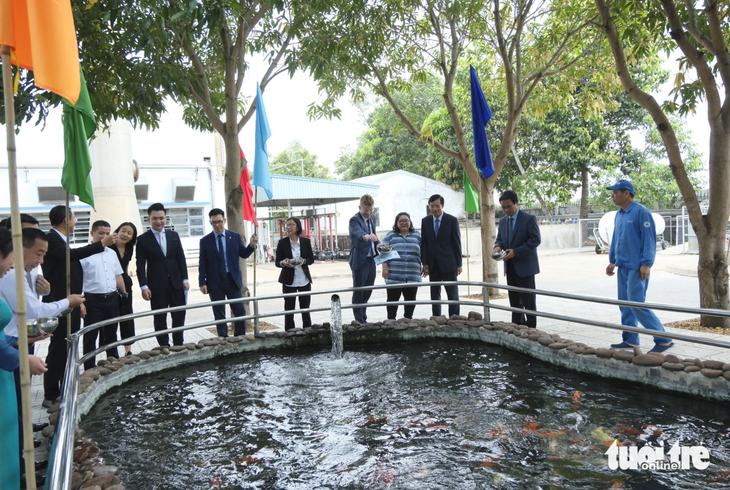 Guests visit a Koi fish pond which uses wastewater treated by the Vinamilk dairy factory. Photo: Doan Hoa / Tuoi Tre