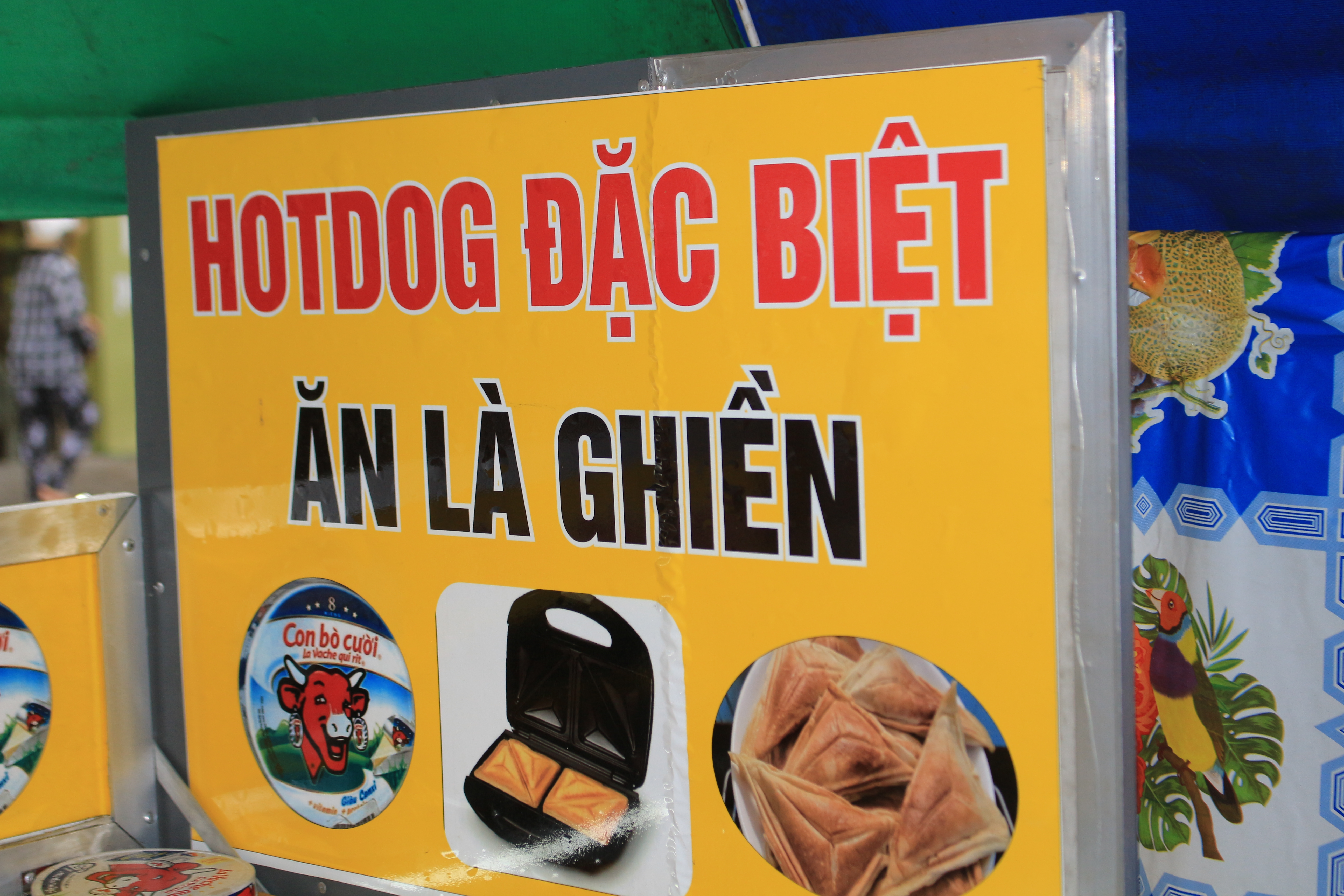 A sign reads 'Special hot dog - Try and get addicted' at a street stall in Go Vap District, Ho Chi Minh City. Photo: Ray Kuschert / Tuoi Tre News