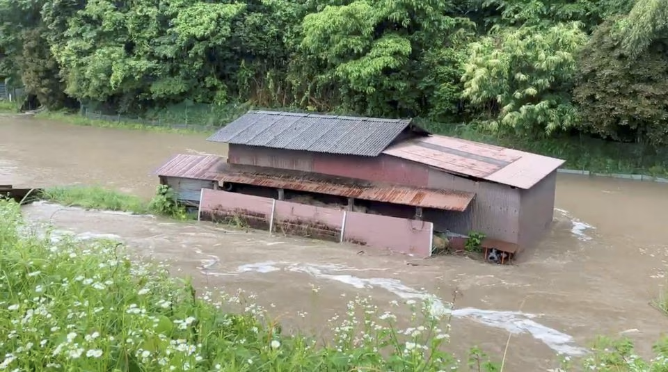 A view of a river overflowing due to the heavy rains in Kizugawa City, Kyoto prefecture, Japan, June 2, 2023, in this screengrab obtained from a social media video. Tom Fay/via Reuters