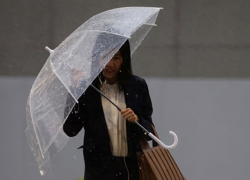 A woman holding an umbrella makes her way in the heavy rain in Tokyo, Japan, June 2, 2023. Photo: Reuters