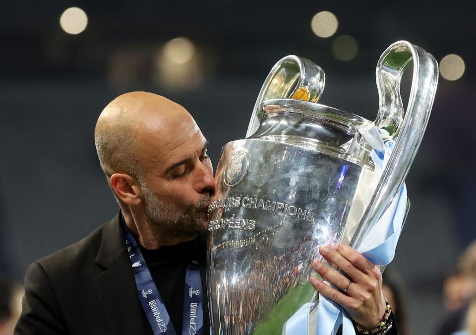 Soccer Football - Champions League Final - Manchester City v Inter Milan - Ataturk Olympic Stadium, Istanbul, Turkey - June 11, 2023 Manchester City manager Pep Guardiola kisses the trophy as he celebrates winning the Champions League. Photo: Reuters