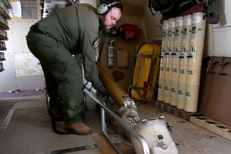 A crew member of a Royal Canadian Air Force CP-140 Aurora maritime surveillance aircraft of 14 Wing drops sonar buoys as it flies a search pattern for the missing OceanGate submersible, over the Atlantic Ocean off Newfoundland, Canada, June 20, 2023 in a still image from video. Photo: Reuters