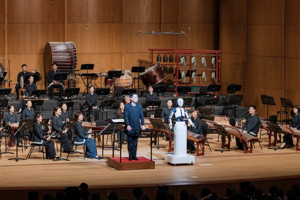 An android robot, EveR 6, is seen as it takes the conductor's podium to lead a performance by South Korea's national orchestra with human conductor Choi Soo-yeoul, in Seoul, South Korea, June 30, 2023, in this handout picture. National Theater of Korea/Handout via Reuters