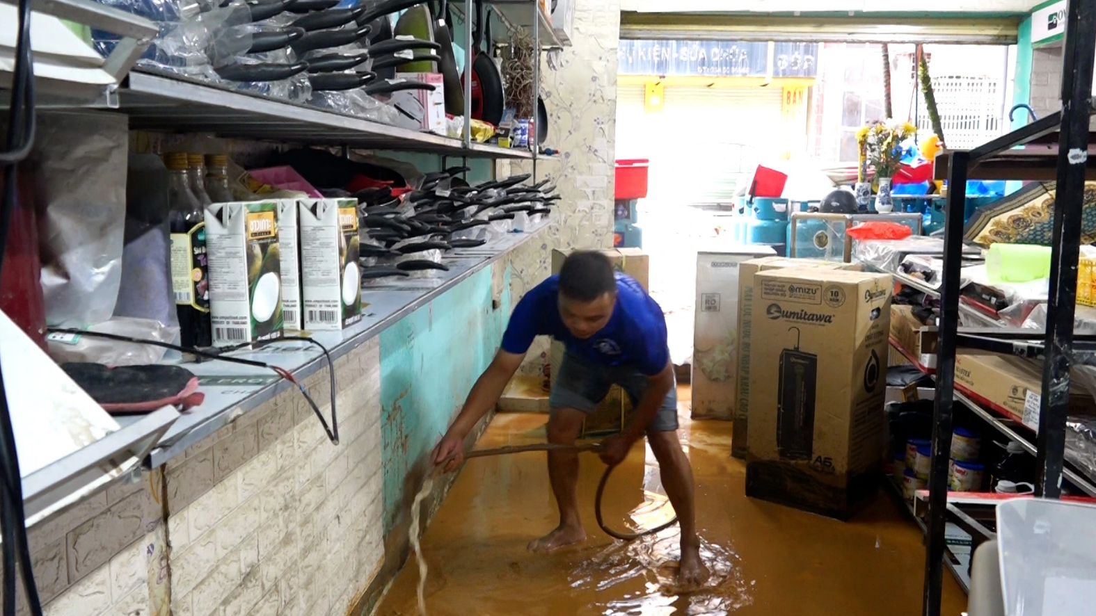 A man in Vinh Quang Town in Hoang Su Phi District cleans his house after heavy rains on July 5, 2023. Photo: Supplied