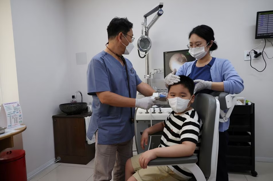 Pediatrician Song Jong-geun performs medical treatment at his pediatric clinic in Seoul, South Korea, June 14, 2023. Photo: Reuters