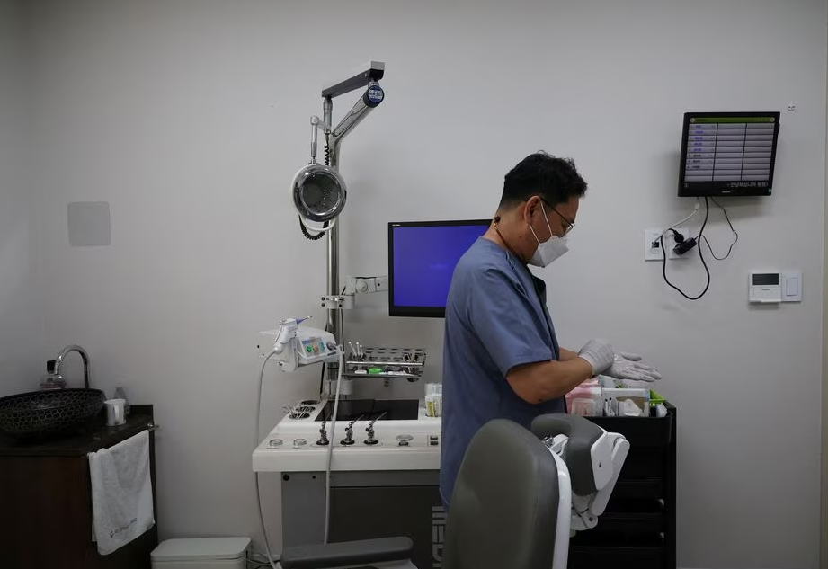 Pediatrician Song Jong-geun gets ready at his pediatric clinic in Seoul, South Korea, June 14, 2023. Photo: Reuters