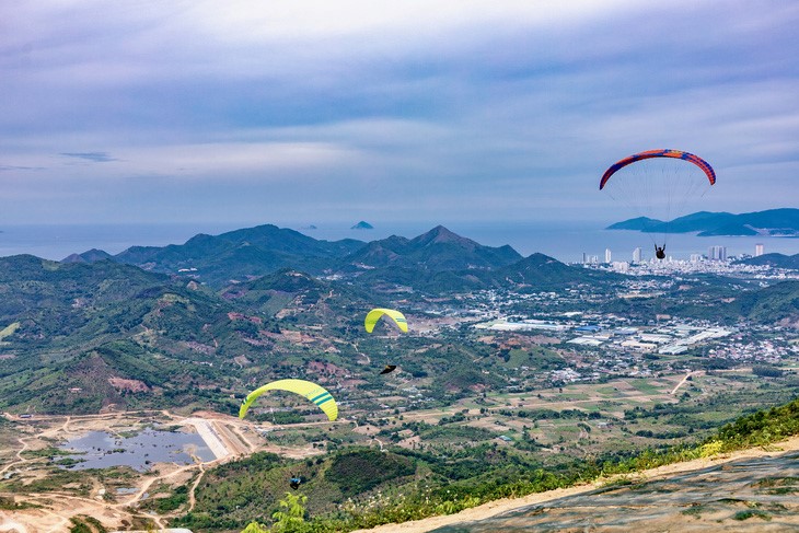 Paragliders admire the beauty of the entire Nha Trang City, Khanh Hoa Province. Photo: Do Phuong / Tuoi Tre