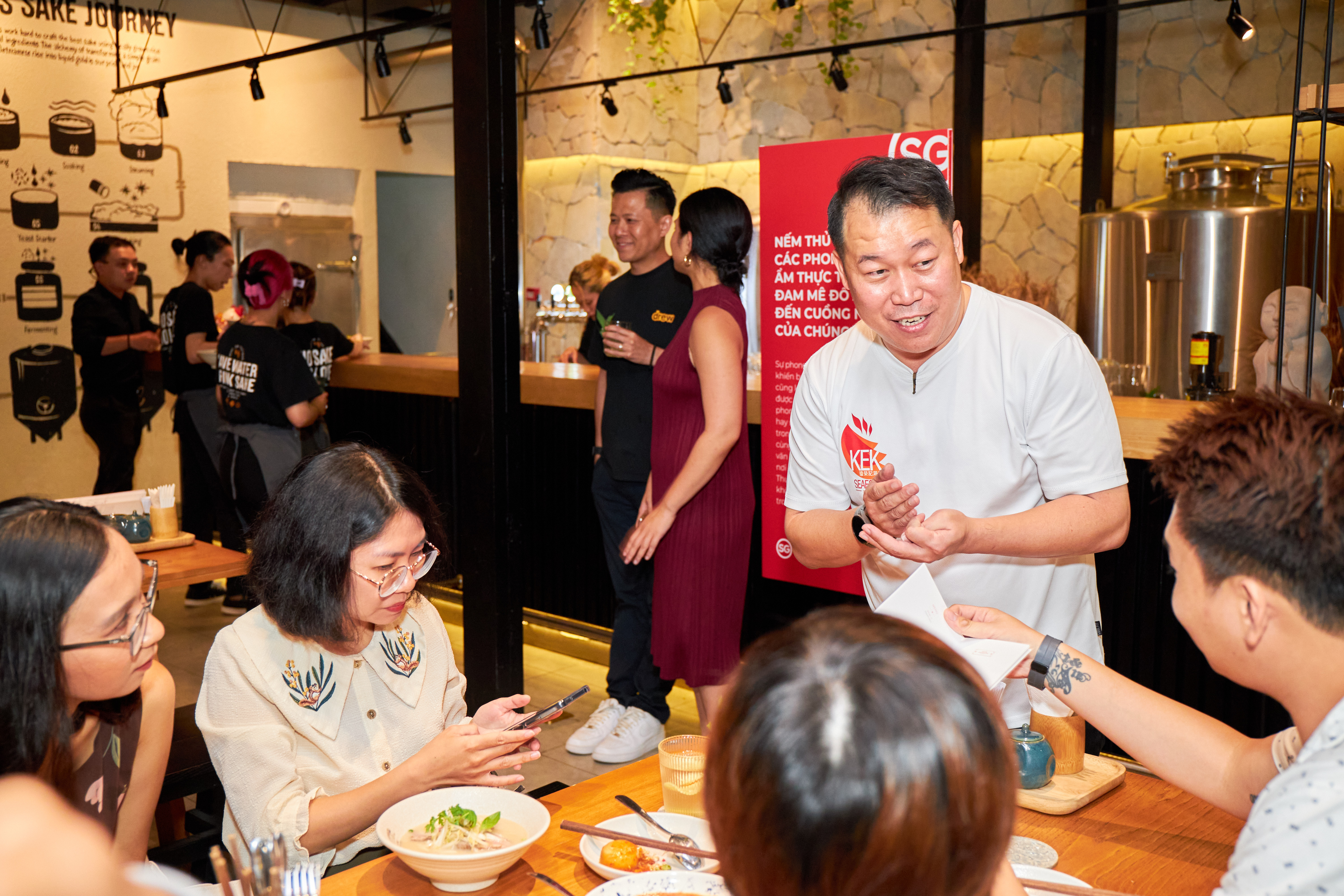 Paul Liew, co-owner of KEK Seafood, talks to guest at a media event for the Singapore Tourism Board's Tatse Obsession campaign in Ho Chi Minh City on July 28, 2023. Photo: STB