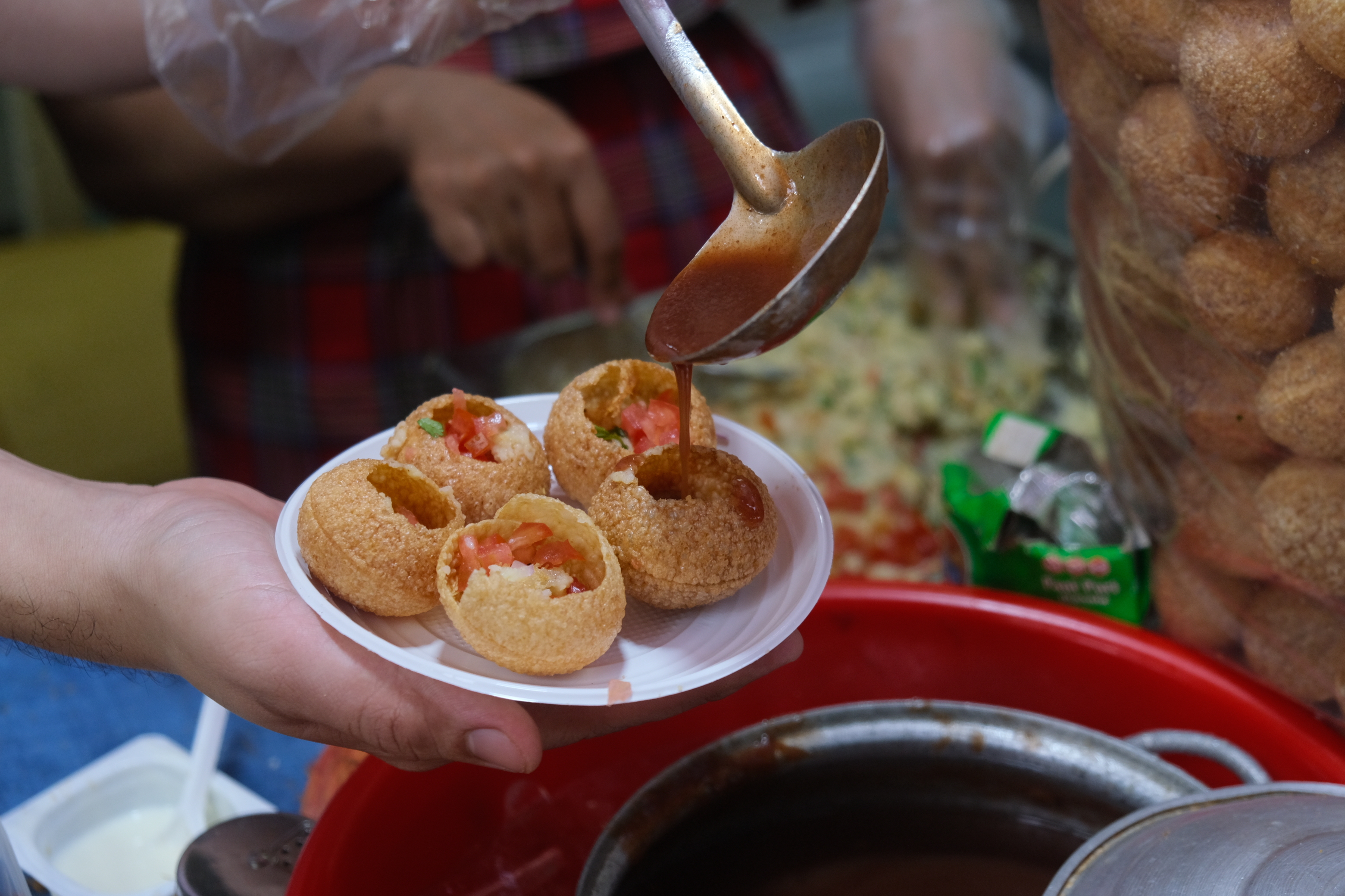Tamanrid sauce is poured over panipuri for serving diners to Ho Thi Ky Food Street in Ho Chi Minh City. Photo: Ngoc Phuong / Tuoi Tre News