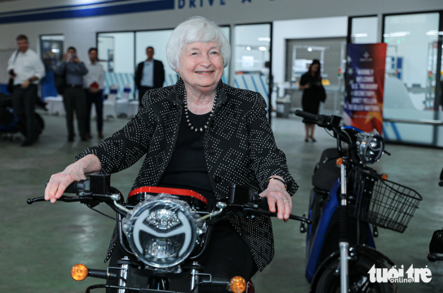 U.S. Treasury Secretary Yellen sits on an electric scooter made by Vietnamese start-up Selex Motors. Photo: Danh Khang / Tuoi Tre